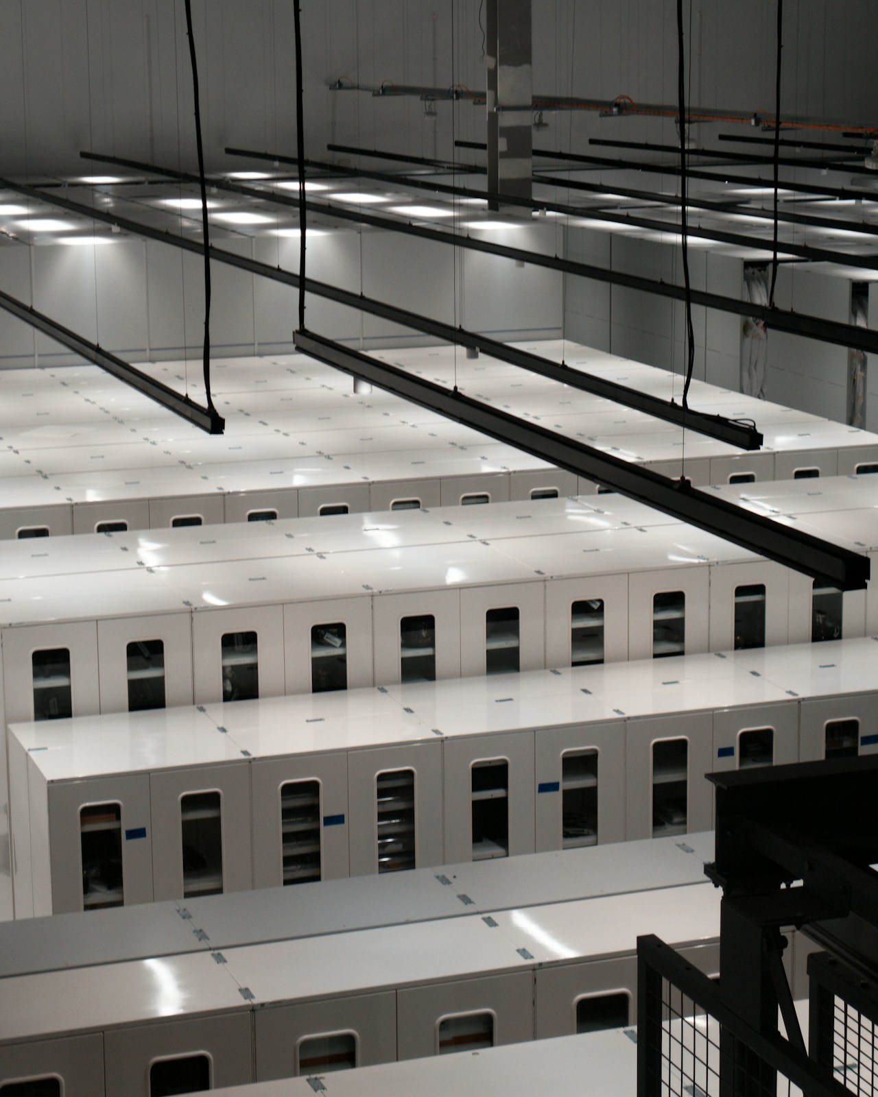 Modern data center aisle with white server cabinets